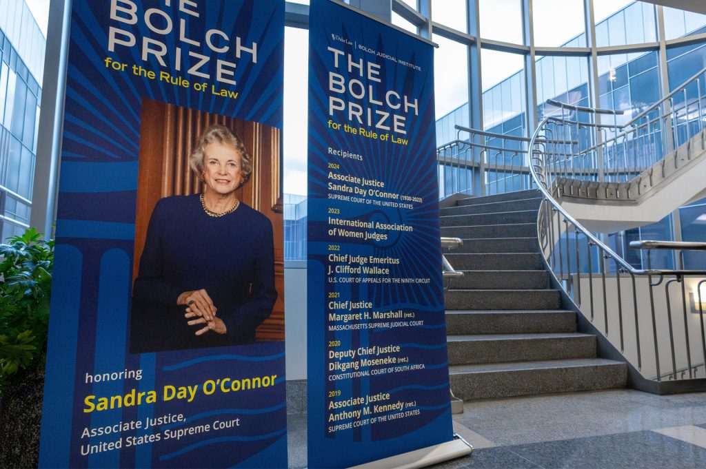 Photo of signage featuring Sandra Day O'Conner at a law school stairwell