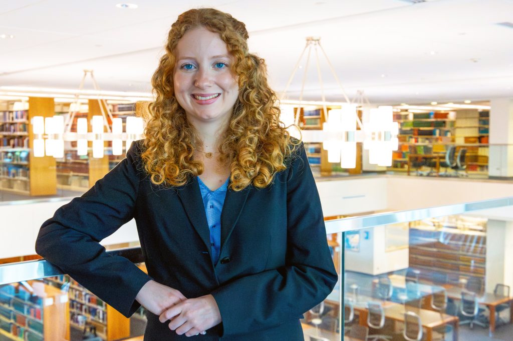 Photo of woman powing in law library