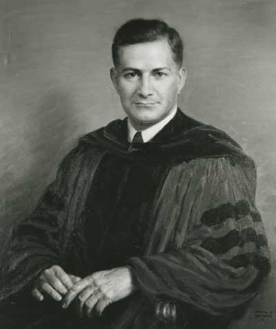 Black and white photo of man in academic robes