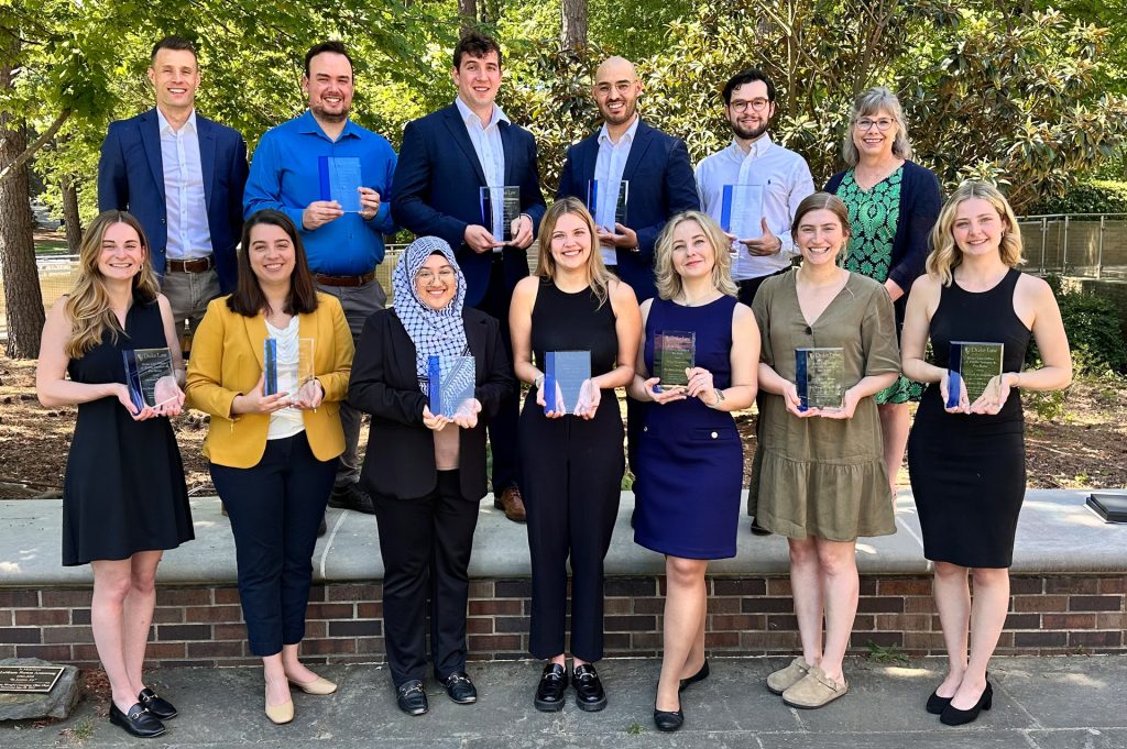 Group photo of students holding awards